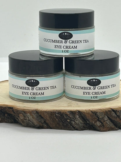Three jars of Cucumber & Green Tea  eye cream on a wood slab