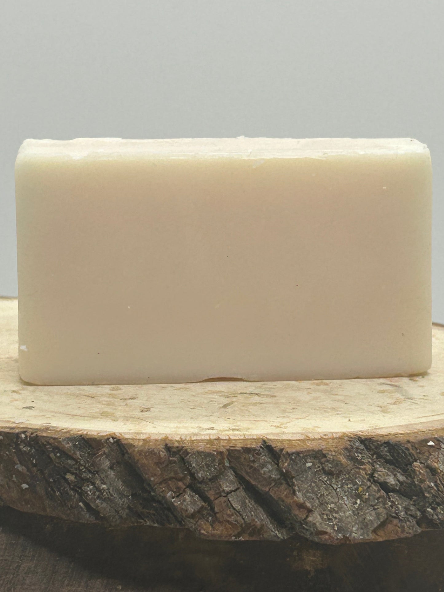A Bar of 100 percent beef tallow soap on a wood plank