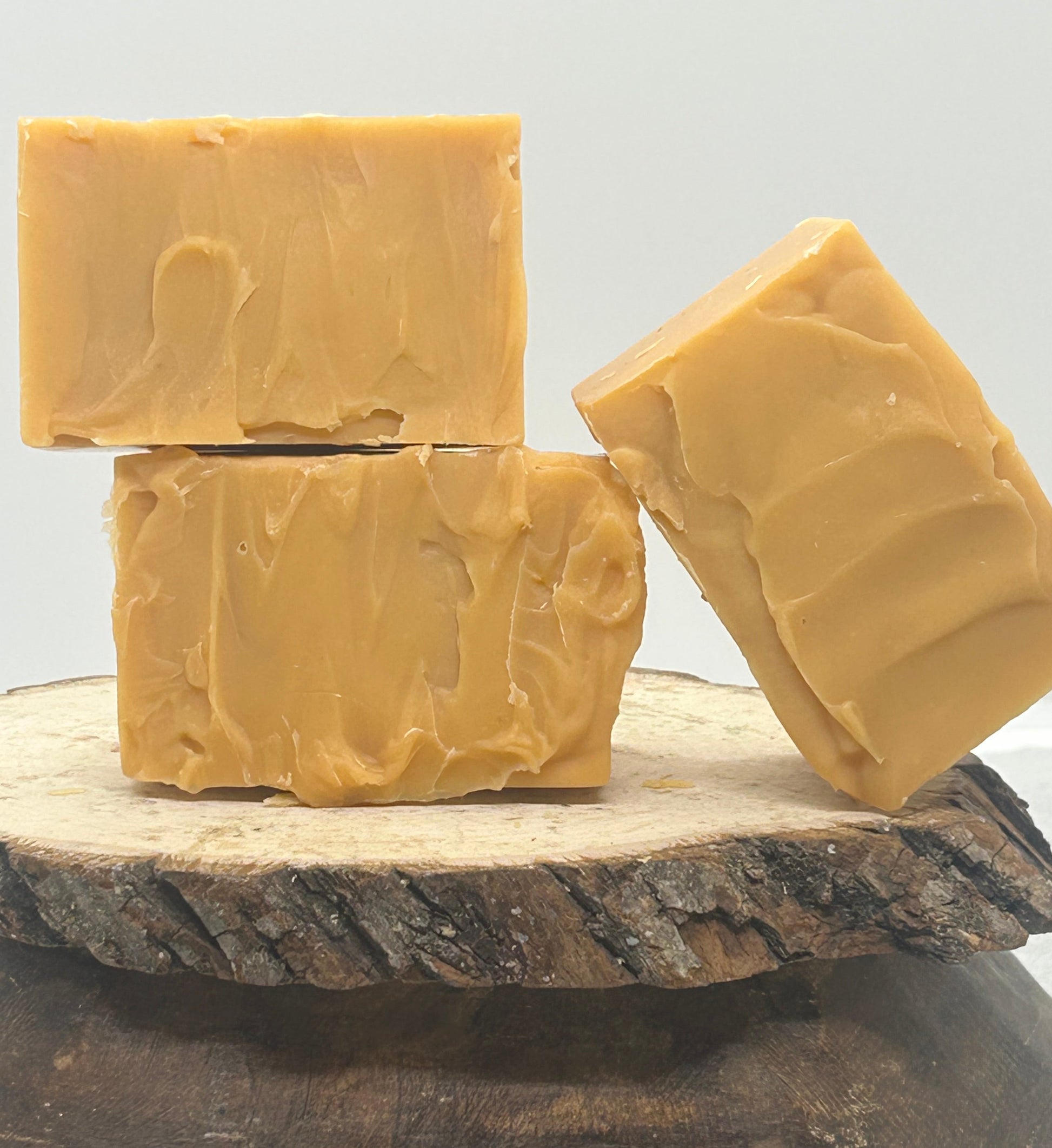 Three Grapefruit  Goat Milk soaps on a wood slab